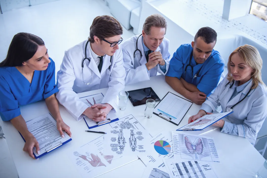 Healthcare leadership team reviewing operational reports together